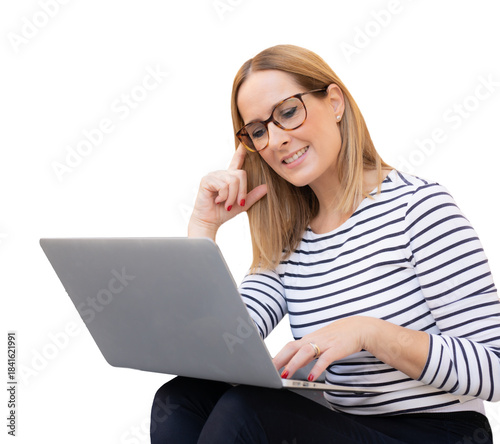 Young smiling woman wearing eyeglasses and a striped shirt, working with laptop computer over transparent background. Business concept.