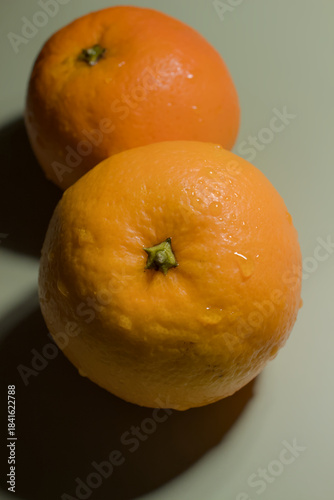 Two oranges with water drops on the surface