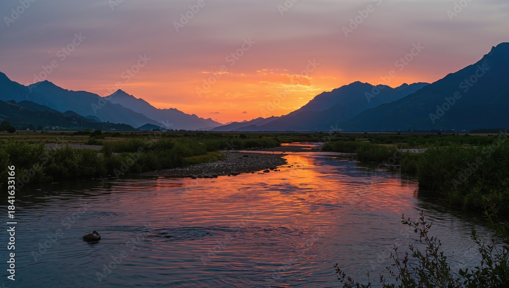 Fototapeta premium Sunset scene with water and mountain landscape, vibrant sky and evening light, summer setting, World Environment Day