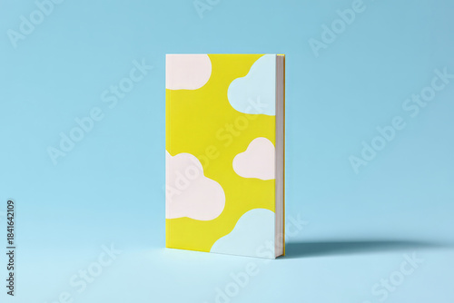 Colorful hardcover book with cloud patterns on blue background