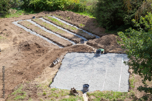 Primary and secondary gravel and sand filter beds for a domestic septic tank, elevated angle showing the layout during installation, waste water management