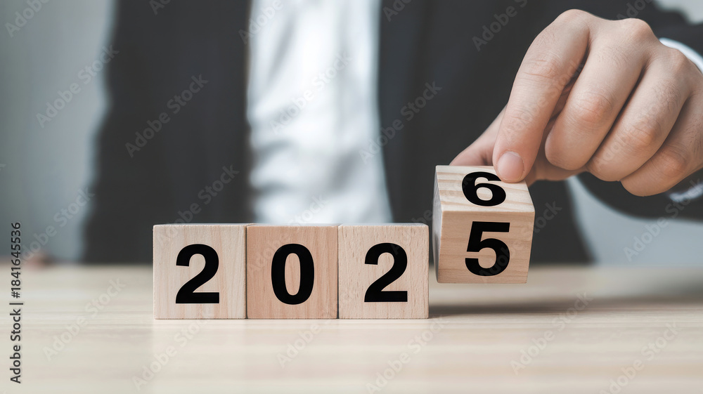 Naklejka premium Changing year from 2022 to 2025 with wooden blocks