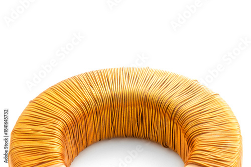 Fotografija Electric transformer copper coil inductor on white background, close-up