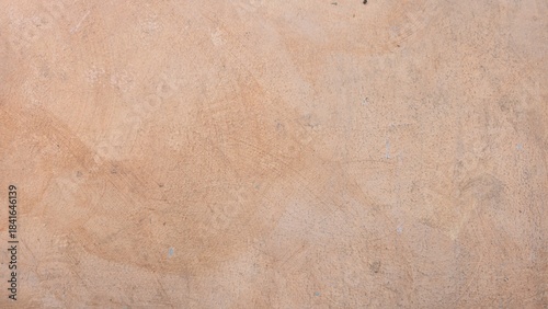 Obraz na płótnie Rough and uneven old peach-painted stucco wall surface with minor stains and uneven brush marks