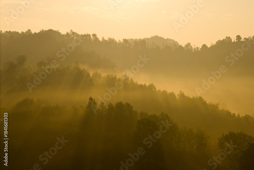 Foto Misty hills unfold in Hubei province, China, as soft light bathes the rolling landscape