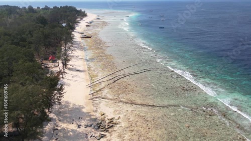 Tropical white sand beach aerial view by drone. Gili Islands ocean aerial landscape in Lombok, Bali, Indonesia