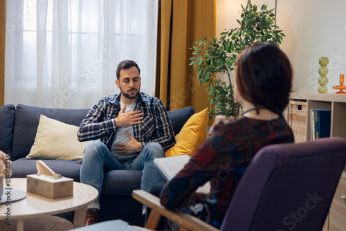 Man practicing breathing exercise during psychotherapy session