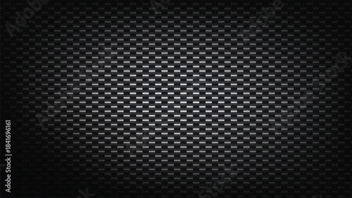 Dark carbon fiber texture background with subtle spotlight effect