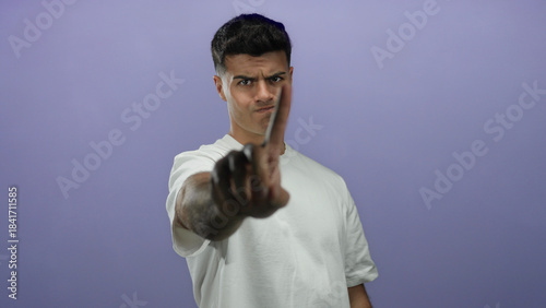 Man gesturing no with finger on purple background isolated view of expression body language and emotion conveying negation warning caution and rejection signs