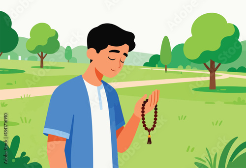 Young man with eyes closed holds prayer beads in a park
