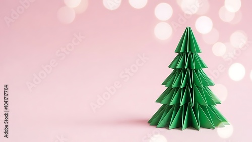 Origami christmas tree on pink background