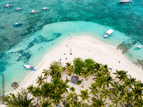 Guyam Island, Siargao, Philippines. Tropical island with a turquoise ocean and boats