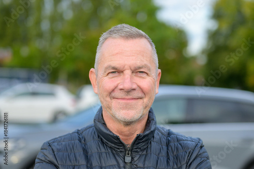 Mature Man Smiling Outdoors Confidently