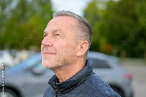 Mature Man Looking Upwards Thoughtfully
