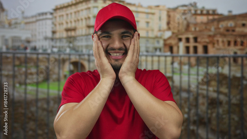 Man claps hands by ancient roman building ruins against clear bright sky in midday light; celebration joy.