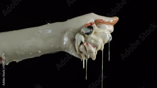 a girl squeezes a chocolate-covered berry in her hand