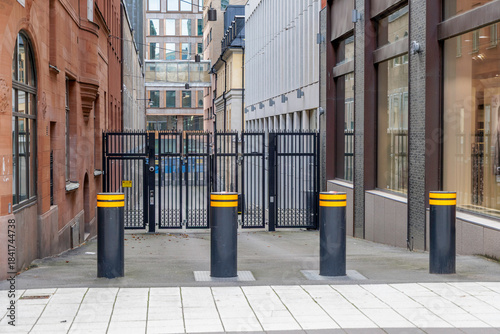 Photography Urban Alleyway with Bollards and Secure Gates