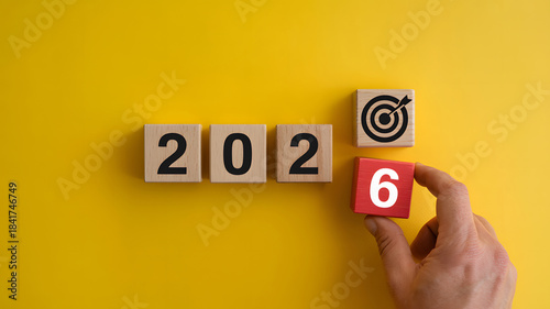 Reaching 2026 goals by setting the final target with hand placing red number block