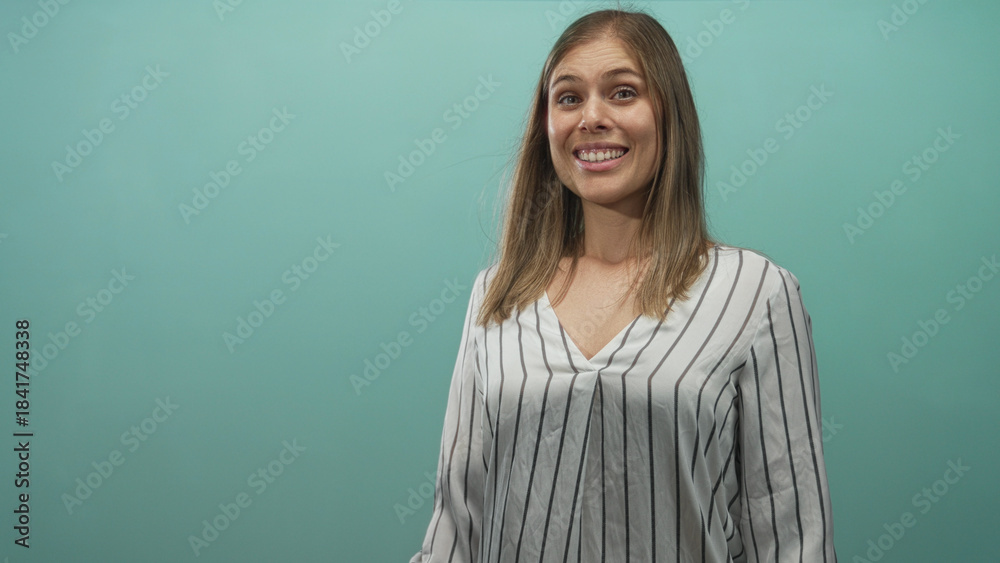 Obraz premium Young blonde woman face shifting from smile to sad frown in studio with teal wall; melancholy transition.