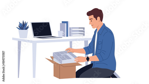 Man setting up office supplies at a desk with a laptop and plant