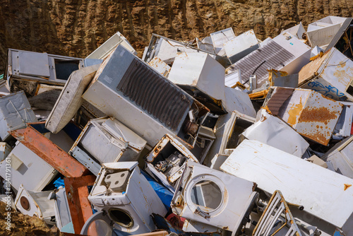 Abandoned and broken appliances in a junk yard setting