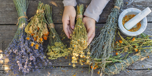 Photos Woman with dried medicinal herbs. Selective focus.