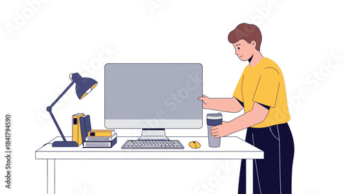 A man in a yellow shirt at his desk with a computer and a coffee cup