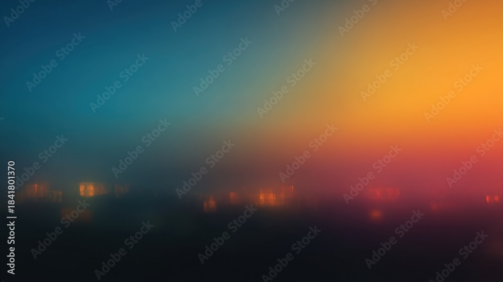 Obraz premium A mix of warm and cool colors fills the sky as night falls over a city. Soft lights from buildings create a blurred effect against the vibrant background.