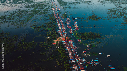 Kampong Phluk floating village with stilt houses on Tonle Sap lake in Cambodia.