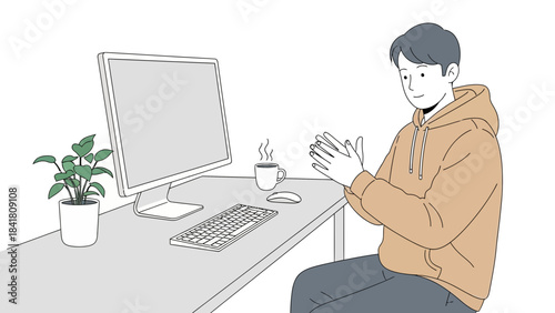 A man clapping hands at his office desk with a coffee mug and a computer monitor
