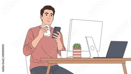 A man in an office setting cleaning his phone while looking at a computer at his desk