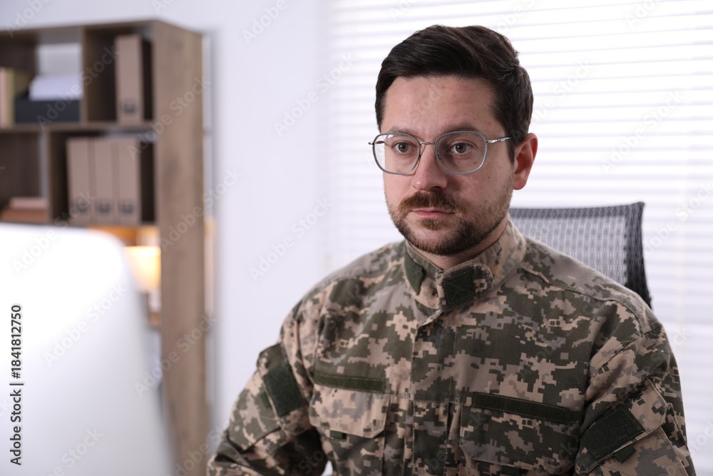 Fototapeta premium Military man working on computer in office