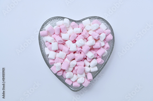 small marshmallows in a heart-shaped bowl close-up