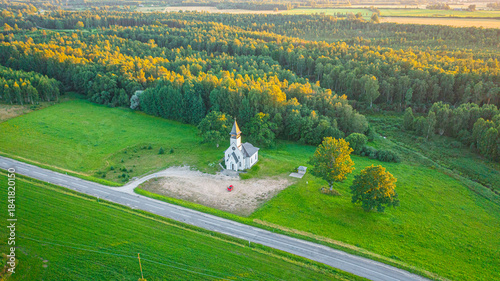 Aerial photo from drone to Igate church at sunset on a beautiful summer evening. Vidrizi, Limbazi, Latvia. (Series)