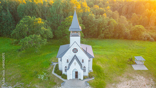 Aerial photo from drone to Igate church at sunset on a beautiful summer evening. Vidrizi, Limbazi, Latvia. (Series)