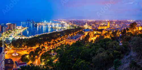 Malaga, Andalusia, Spain: Panoramic aerial view of Malaga coastline, Malaga Cathedral, the old town, port and Malaga Marina at twilight