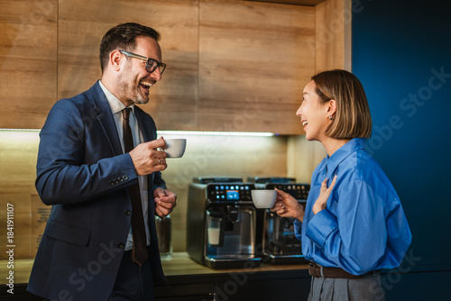 Fotografie Business colleagues laughing enjoying coffee break in office