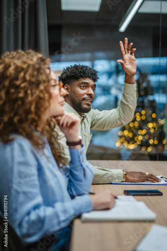 Фотография Business man raising hand asking question during meeting
