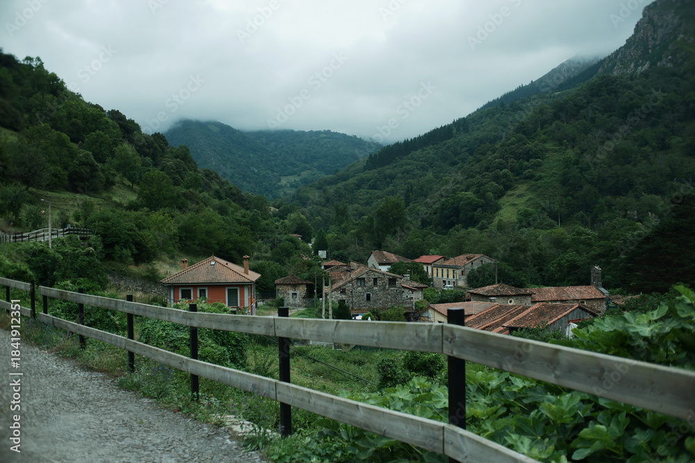 Naklejka premium Scenic hiking trail with a view of a traditional small village in Northern Spain. Senda del Oso, Asturias