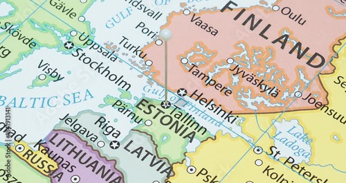 A zoom out of a white pin into tallinn city of estonia political map