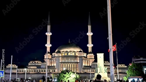 Istanbul, Turkey, August 1, 2025. Slow-motion nighttime footage of Taksim Square. The New Taksim Mosque, illuminated by night lights, dominates the square. City life and tourist attractions.