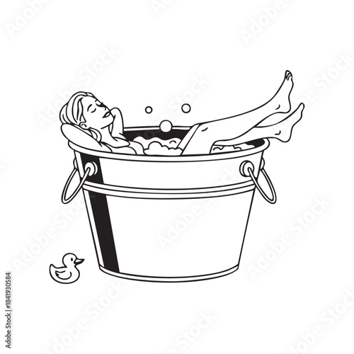 Woman relaxing in a bubble bath in a large metal bucket with rubber duck bubbles