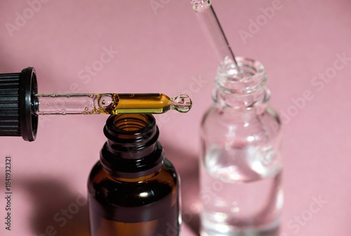 Eco-Friendly Beauty Serum with Dropper Glass Bottle: Hydrating and Moisturizing Skincare with Essential Oils and Organic Ingredients on Pink Background
