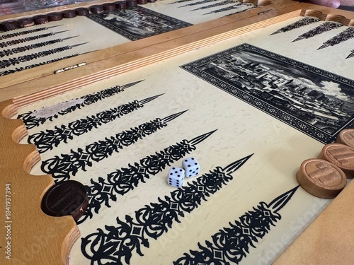 Board for a game of backgammon on a wooden table . Blocks on a wooden background . Cropped image of backgammon playing on a wooden board over the white background
