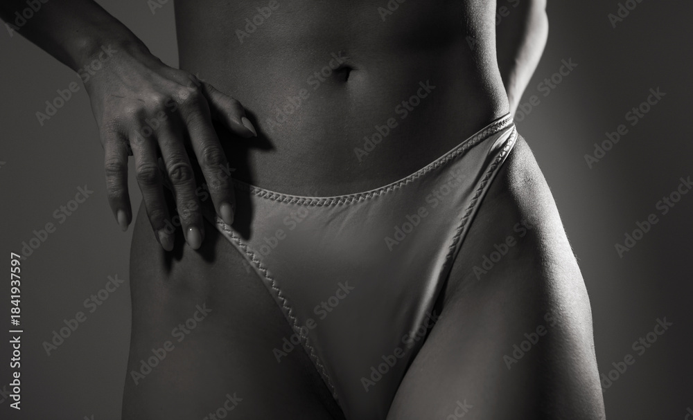 Naklejka premium Perfect body of young and beautiful woman. Sensual body. Shadow. Sensual. Diet. 