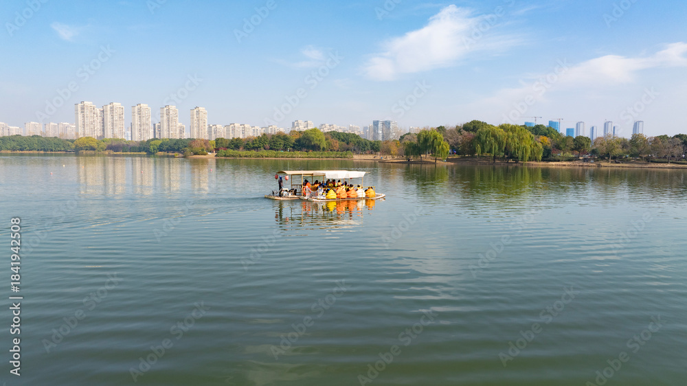 Fototapeta premium Urban Lake Cruise with Tourists in Life Jackets on Sunny Day