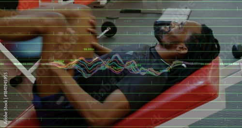Male athlete pushing footplate and training legs with leg press reps in gym, waveform grid tracking