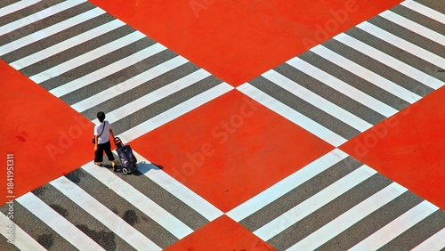 Person Walking with Shopping Cart on a Colorful Pedestrian Crossing
