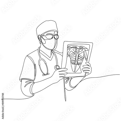 Doctor analyzing x-ray image while wearing medical scrubs and mask  