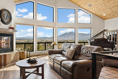 Spacious Room Offering Panoramic Views Of Distant Mountains And Valley Illuminated By Natural Light